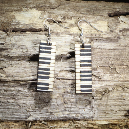 Hand-painted wooden wide piano keyboard dangle earrings featuring realistic black and white piano keys on hypoallergenic .925 sterling silver hooks. Lightweight music jewelry for pianists, piano teachers, music students, choir directors, musicians, and classical music enthusiasts.