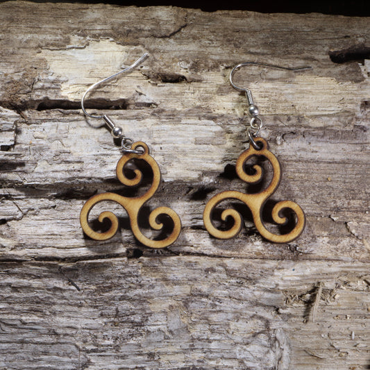 Handcrafted Celtic Triskele wooden dangle earrings featuring the traditional Irish triple spiral symbol. Lightweight laser-cut wooden earrings with hypoallergenic .925 sterling silver hooks, perfect for Celtic jewelry lovers, Irish heritage, pagan and spiritual accessories, and everyday wear.