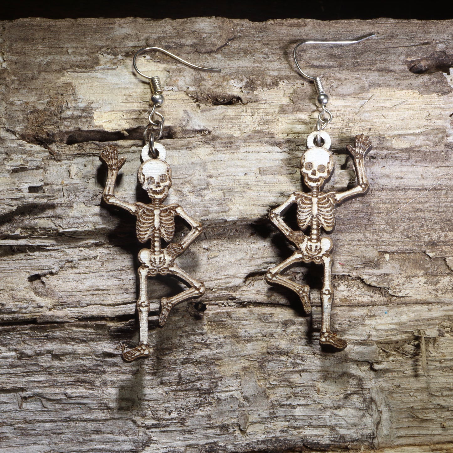 Handcrafted Dancing Skeleton wooden dangle earrings featuring a playful full-body skeleton in a dancing pose. Lightweight laser-cut wooden earrings with hypoallergenic .925 sterling silver hooks, perfect for Halloween lovers, anatomy enthusiasts, gothic fashion, spooky season, Day of the Dead celebrations, and skeleton jewelry collectors.