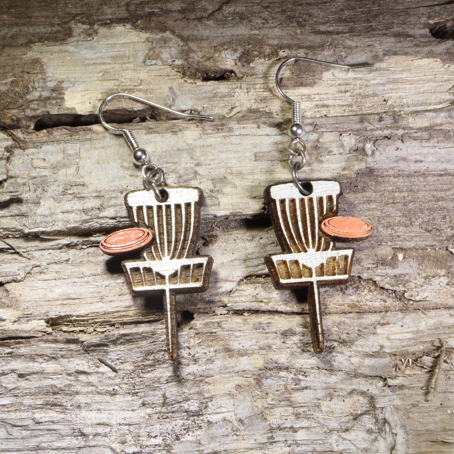 Handcrafted Disc Golf Basket wooden dangle earrings featuring a disc golf target basket with an orange flying disc. Lightweight laser-cut wooden earrings with hypoallergenic .925 sterling silver hooks, perfect for disc golf players, frisbee golf enthusiasts,  outdoor sports lovers, and unique sports jewelry.