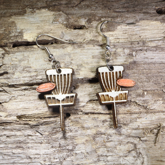 Handcrafted Disc Golf Basket wooden dangle earrings featuring a disc golf target basket with an orange flying disc. Lightweight laser-cut wooden earrings with hypoallergenic .925 sterling silver hooks, perfect for disc golf players, frisbee golf enthusiasts,  outdoor sports lovers, and unique sports jewelry.