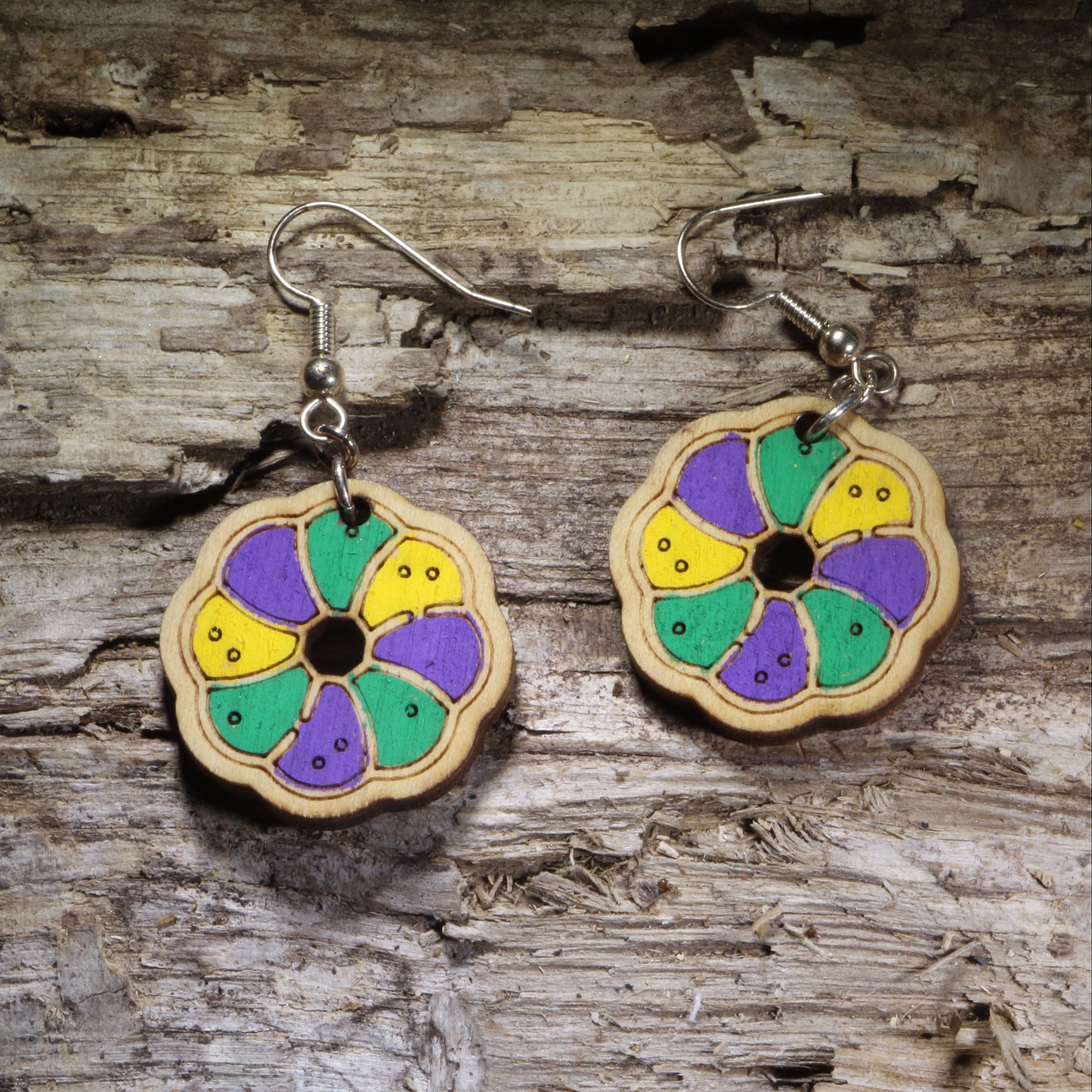 Handcrafted King Cake wooden dangle earrings featuring a colorful Mardi Gras king cake slice design in traditional purple, green, and gold. Lightweight laser-cut wooden earrings with hypoallergenic .925 sterling silver hooks, perfect for Mardi Gras celebrations, Fat Tuesday, New Orleans festivals, Louisiana pride, bakeries, and handmade festive jewelry.