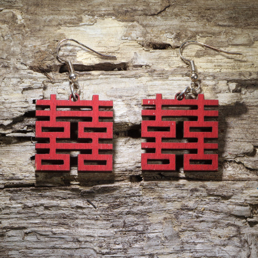 Handcrafted red wooden dangle earrings featuring the traditional Chinese Double Happiness (囍) symbol. Lightweight cultural celebration earrings with hypoallergenic .925 sterling silver hooks, perfect for Chinese weddings, Lunar New Year, anniversaries, cultural events, and meaningful handmade jewelry.