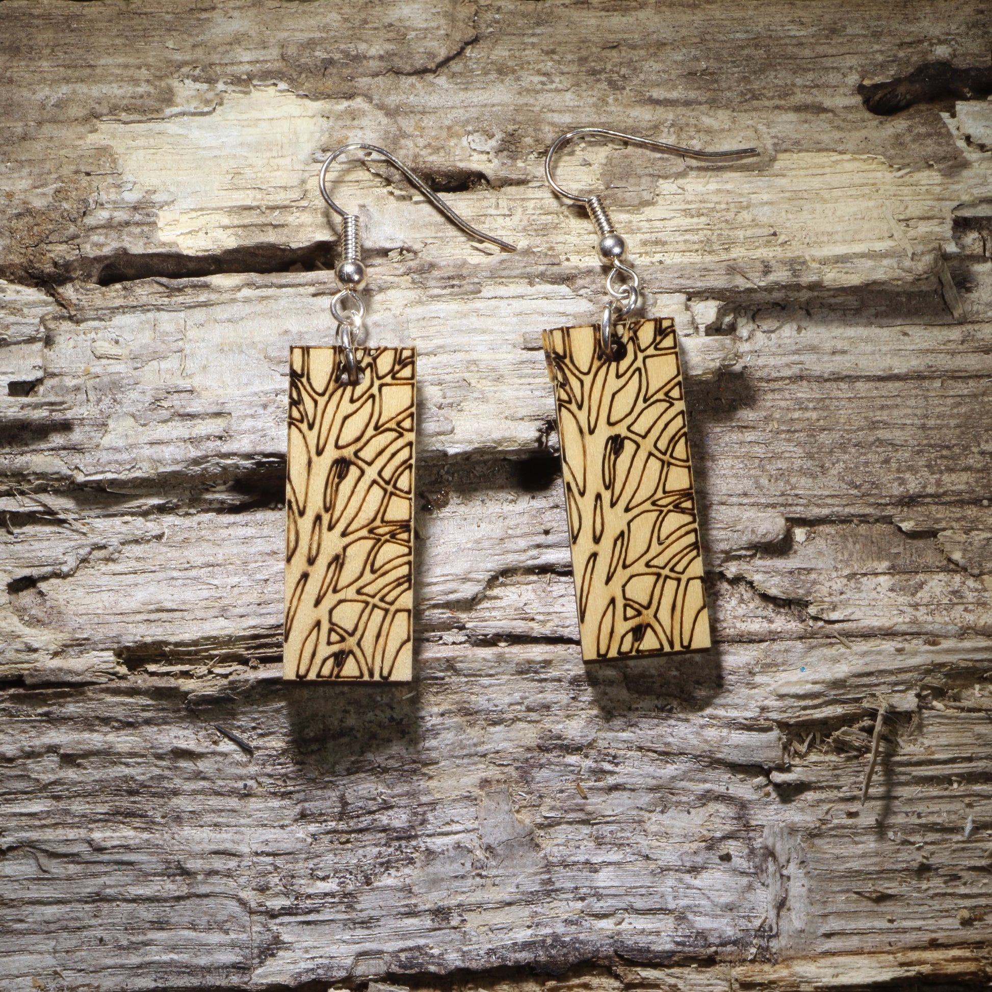 Handcrafted wooden bar dangle earrings featuring an engraved tree bark and wood grain pattern on natural wood. Lightweight nature-inspired earrings with hypoallergenic .925 sterling silver hooks, perfect for forest lovers, rustic style, outdoor enthusiasts, and minimalist handmade jewelry.
