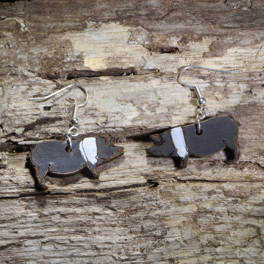 Handmade Hampshire pig wooden dangle earrings featuring detailed laser-cut black Hampshire pigs with signature white shoulder belt markings. Lightweight farm animal earrings crafted from wood with hypoallergenic .925 sterling silver hooks, perfect for pig lovers, farmers, livestock enthusiasts, 4-H and FFA members, homesteaders, and country lifestyle jewelry collectors.
