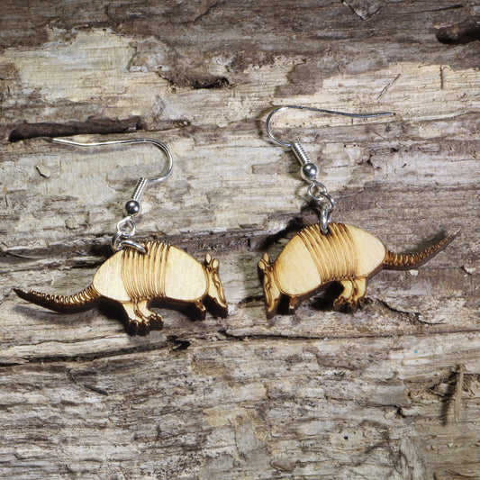 Handmade armadillo wooden dangle earrings crafted from lightweight laser-cut wood with hypoallergenic .925 sterling silver hooks. Wildlife jewelry featuring an armadillo silhouette, perfect for animal lovers, Southwestern style, Texas-inspired gifts, desert wildlife enthusiasts, and nature lovers.