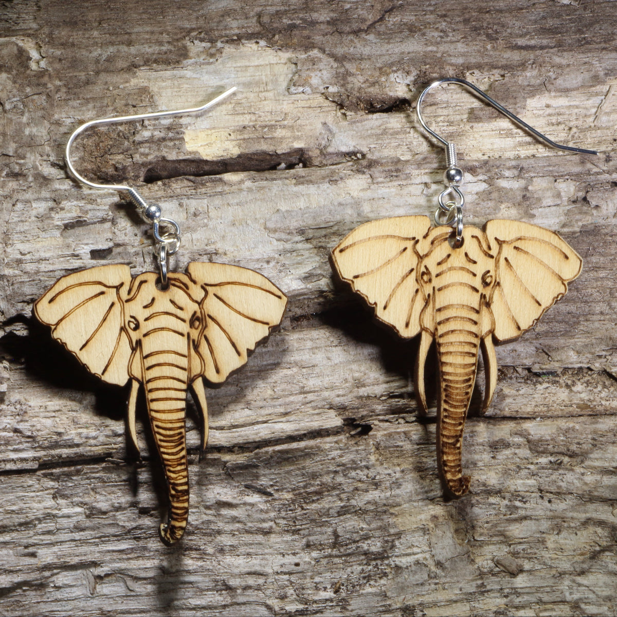Handmade elephant wooden dangle earrings crafted from lightweight laser-cut wood with hypoallergenic .925 sterling silver hooks. African wildlife jewelry featuring a detailed elephant face, perfect for elephant lovers, safari enthusiasts, zoo supporters, nature lovers, and unique animal gifts.