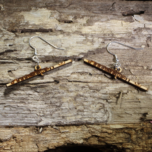 Handmade flute wooden dangle earrings featuring detailed concert flutes with engraved keys. Lightweight music earrings crafted from wood with hypoallergenic .925 sterling silver hooks, perfect for flutists, band members, orchestra musicians, music teachers, flute students, and woodwind enthusiasts.