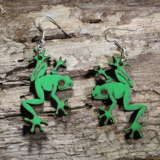 Handmade green tree frog wooden dangle earrings featuring detailed laser-cut frogs with bright green painted finish and red eyes. Lightweight frog earrings crafted from wood with hypoallergenic .925 sterling silver hooks, perfect for amphibian lovers, nature enthusiasts, wildlife fans, rainforest lovers, and unique animal jewelry collectors.