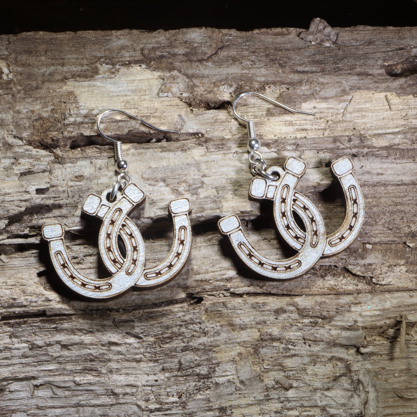 Handmade lucky horseshoe wooden dangle earrings crafted from lightweight laser-cut wood with hypoallergenic .925 sterling silver hooks. Western equestrian jewelry featuring layered horseshoes, perfect for horse lovers, cowgirls, ranch life, rodeo fans, and country western style.