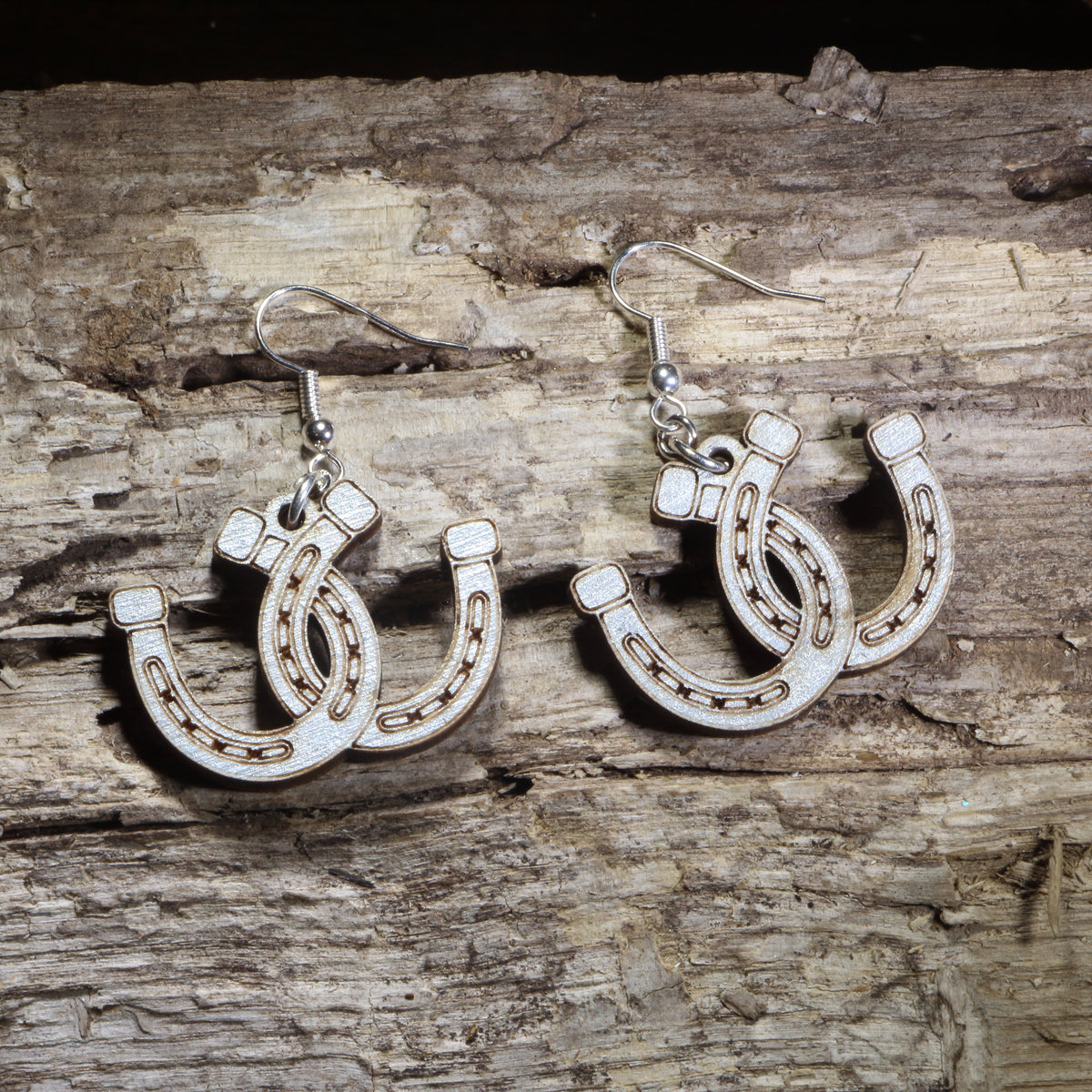 Handmade lucky horseshoe wooden dangle earrings crafted from lightweight laser-cut wood with hypoallergenic .925 sterling silver hooks. Western equestrian jewelry featuring layered horseshoes, perfect for horse lovers, cowgirls, ranch life, rodeo fans, and country western style.