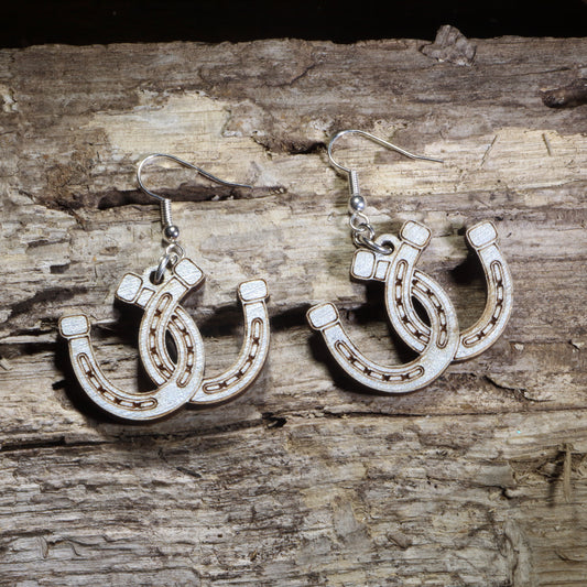 Handmade lucky horseshoe wooden dangle earrings crafted from lightweight laser-cut wood with hypoallergenic .925 sterling silver hooks. Western equestrian jewelry featuring layered horseshoes, perfect for horse lovers, cowgirls, ranch life, rodeo fans, and country western style.