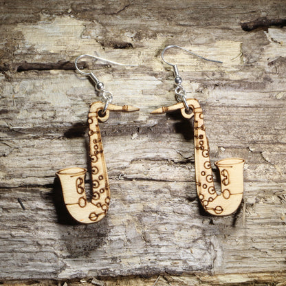 Handmade natural wood saxophone dangle earrings crafted from lightweight laser-cut wood with hypoallergenic .925 sterling silver hooks. Music-themed jewelry perfect for saxophone players, jazz musicians, band members, orchestra performers, and music teachers.