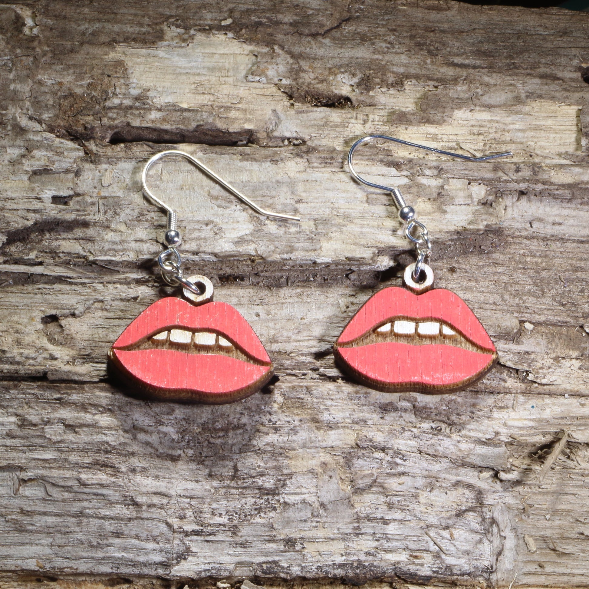 Handmade red lips wooden dangle earrings featuring bold glossy red lips with hand-painted details. Lightweight beauty-inspired earrings crafted from wood with hypoallergenic .925 sterling silver hooks, perfect for makeup lovers, beauty enthusiasts, lipstick fans, cosmetologists, salon professionals, and fun statement jewelry collectors.