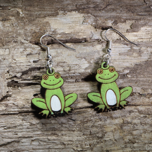 Handmade smiling frog wooden dangle earrings featuring adorable green frogs with white bellies and cheerful expressions. Lightweight frog earrings crafted from wood with hypoallergenic .925 sterling silver hooks, perfect for frog lovers, amphibian enthusiasts, nature lovers, pond wildlife fans, and whimsical animal jewelry collectors.