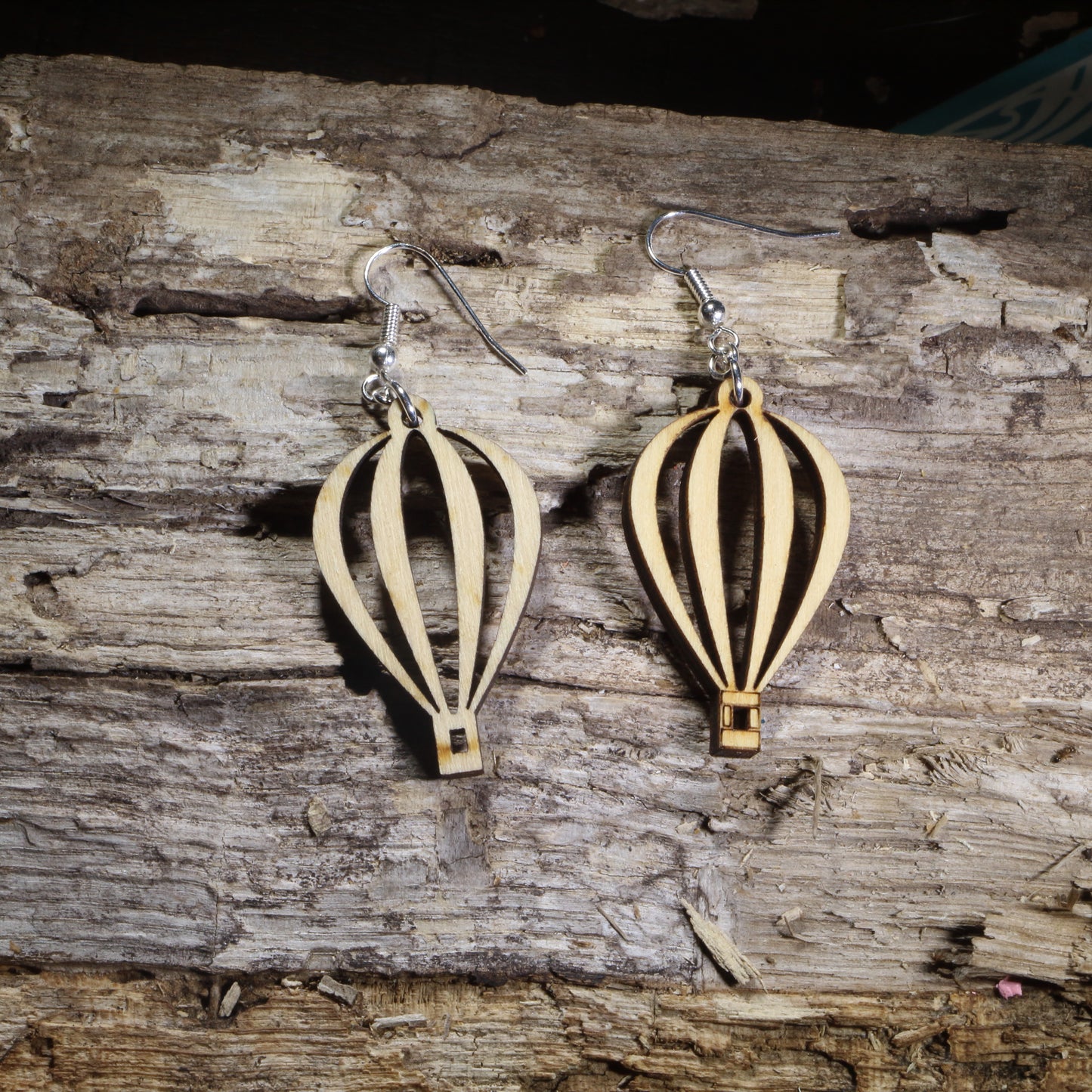 Handmade wooden hot air balloon dangle earrings with an elegant open-cut balloon silhouette on hypoallergenic .925 sterling silver hooks. Lightweight travel-inspired jewelry perfect for hot air balloon enthusiasts, adventure lovers, wanderers, and unique handmade gifts.