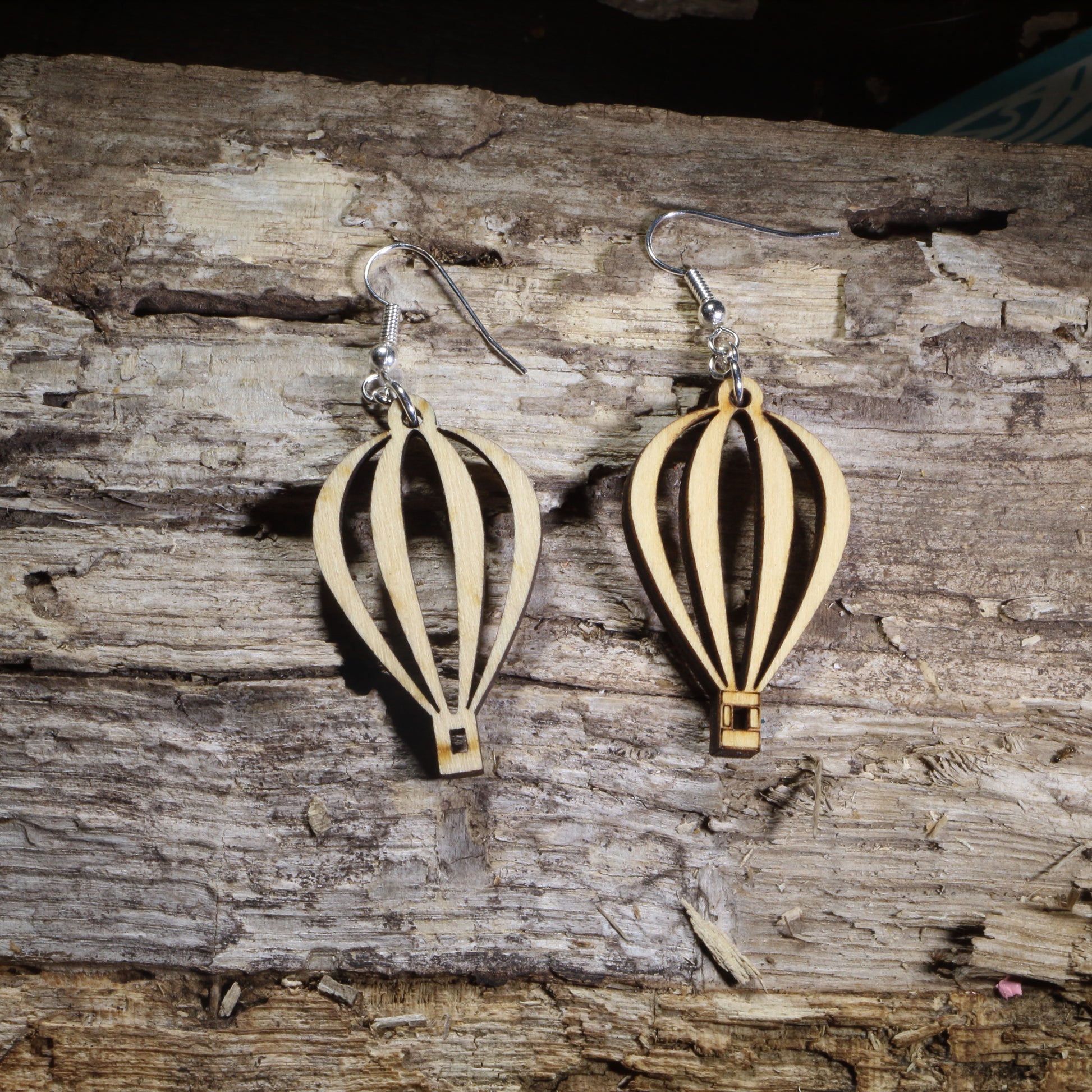 Handmade wooden hot air balloon dangle earrings with an elegant open-cut balloon silhouette on hypoallergenic .925 sterling silver hooks. Lightweight travel-inspired jewelry perfect for hot air balloon enthusiasts, adventure lovers, wanderers, and unique handmade gifts.