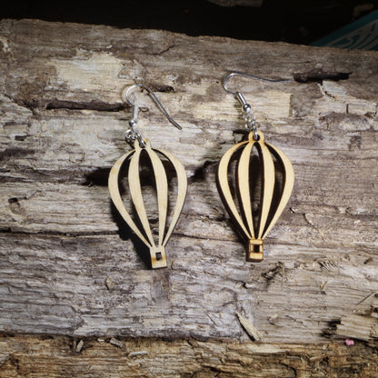 Handmade wooden hot air balloon dangle earrings with an elegant open-cut balloon silhouette on hypoallergenic .925 sterling silver hooks. Lightweight travel-inspired jewelry perfect for hot air balloon enthusiasts, adventure lovers, wanderers, and unique handmade gifts.