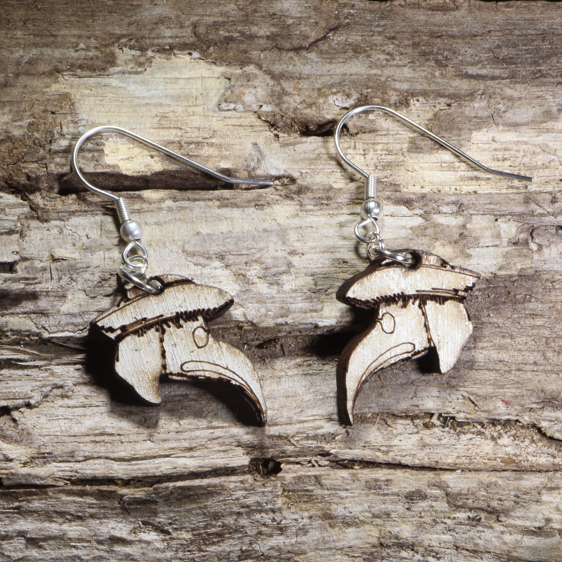Handmade wooden plague doctor mask dangle earrings featuring the iconic beaked plague doctor mask with a wide-brimmed hat on hypoallergenic .925 sterling silver hooks. Lightweight gothic-inspired jewelry for horror fans, dark academia, Halloween, historical costume enthusiasts, and lovers of spooky accessories.