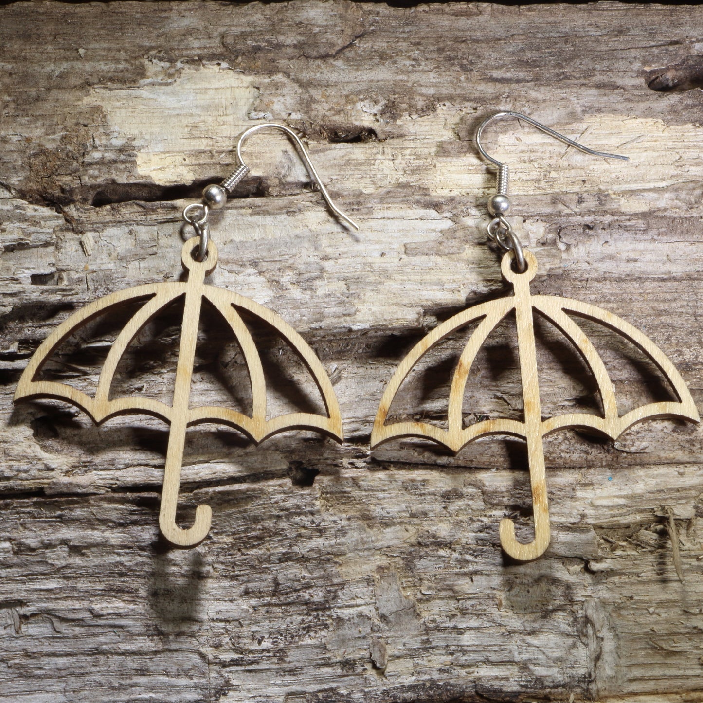 Handmade wooden umbrella dangle earrings featuring an open umbrella silhouette on hypoallergenic .925 sterling silver hooks. Lightweight weather-inspired jewelry for rainy day lovers, spring fashion, umbrella collectors, and unique everyday accessories.