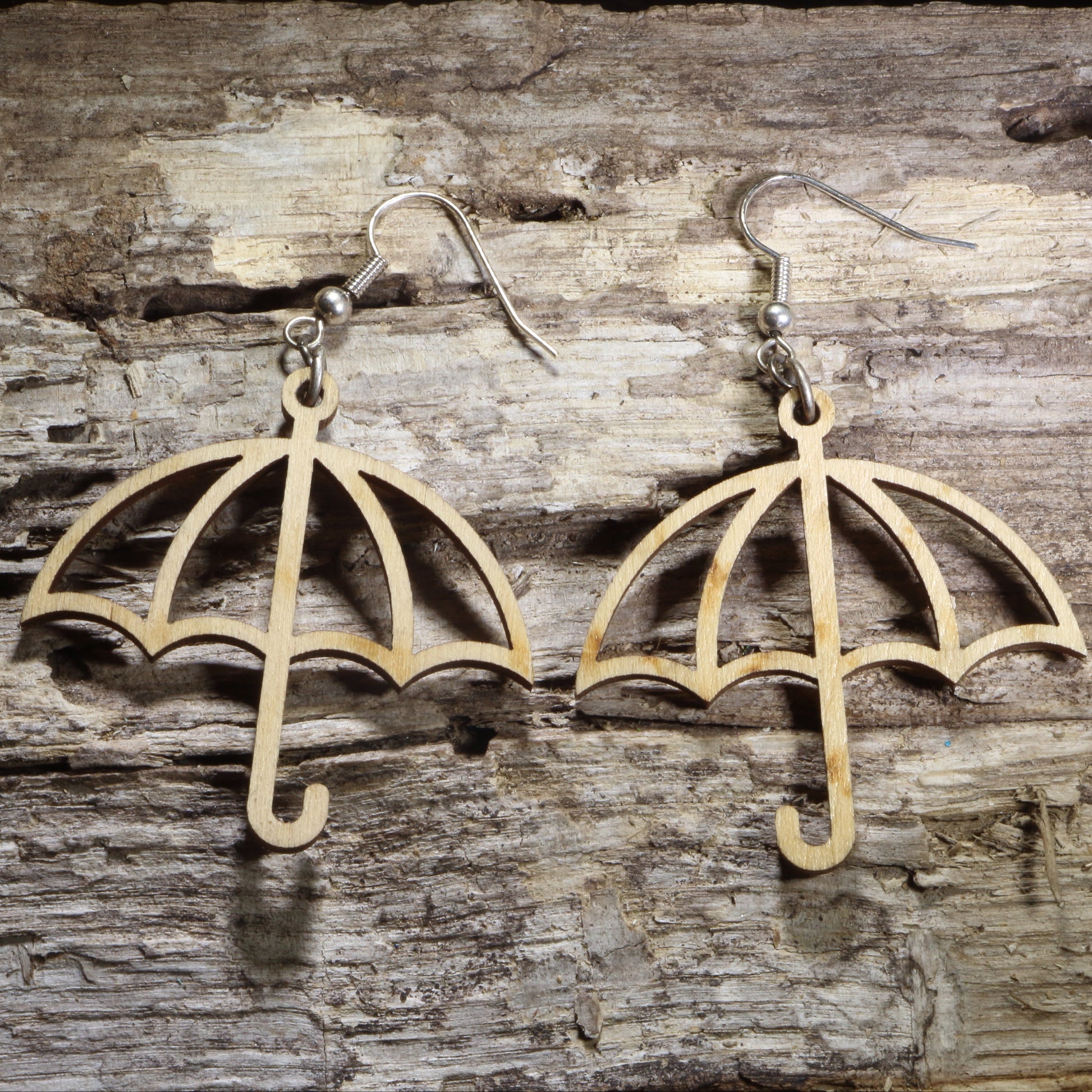 Handmade wooden umbrella dangle earrings featuring an open umbrella silhouette on hypoallergenic .925 sterling silver hooks. Lightweight weather-inspired jewelry for rainy day lovers, spring fashion, umbrella collectors, and unique everyday accessories.