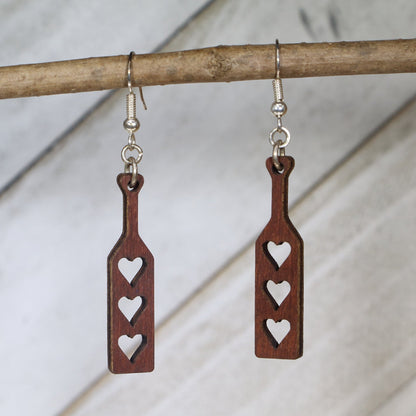Hand-painted wooden heart paddle dangle earrings featuring a playful heart-shaped paddle design with cheeky humor styling and hypoallergenic sterling silver hooks, lightweight jewelry for fun-loving adults and novelty accessory fans