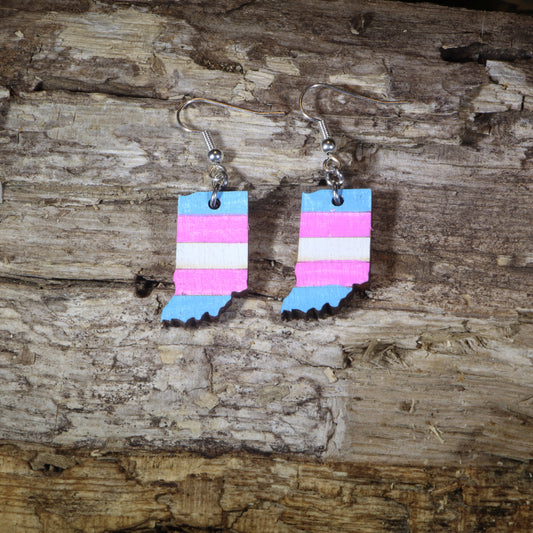 Hand-painted wooden Indiana transgender pride dangle earrings featuring the Indiana state silhouette with pink, blue, and white transgender pride stripes, hypoallergenic sterling silver hooks, and lightweight LGBTQ+ state pride jewelry by Cate's Concepts.
