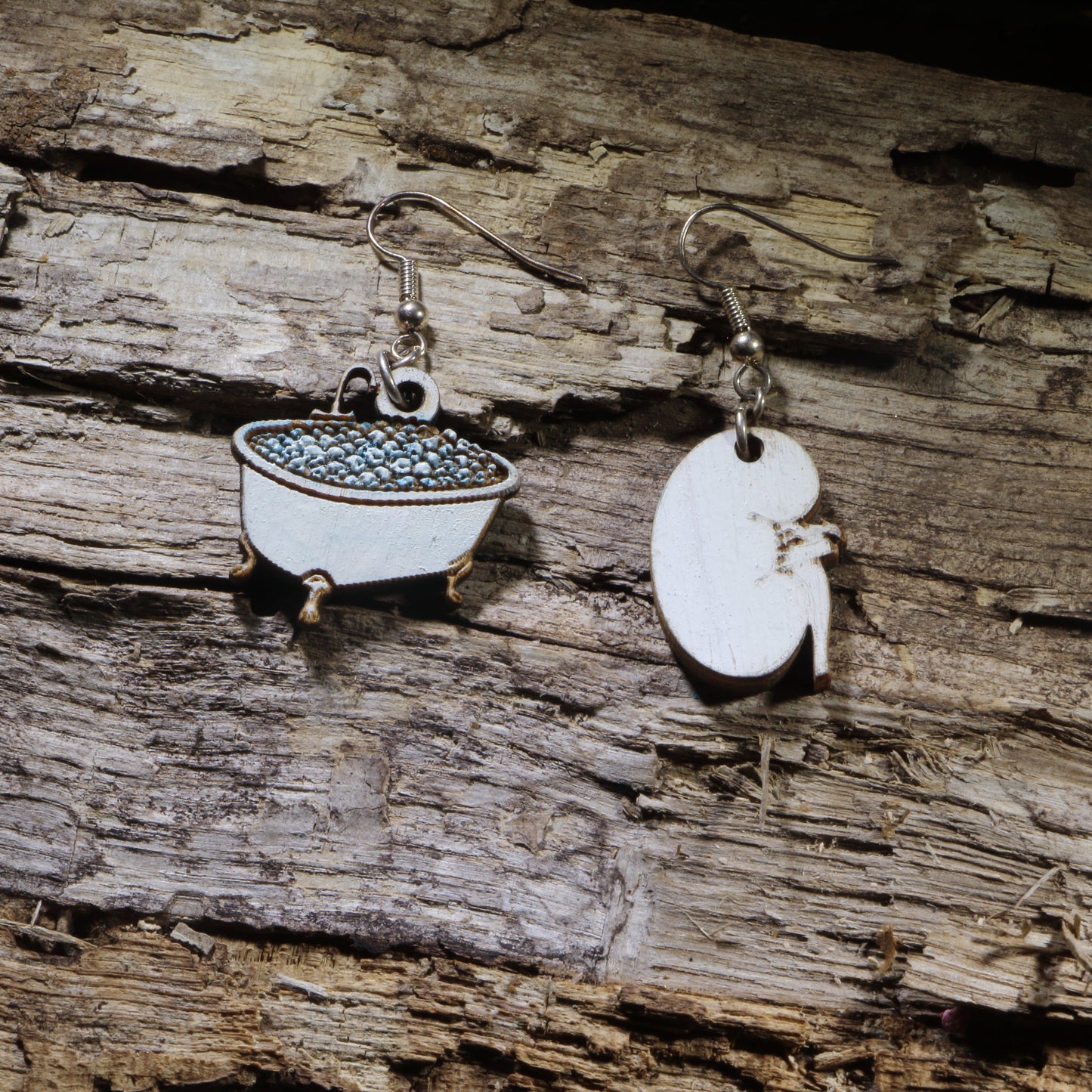 Hand-painted wooden kidney soaking in a bathtub dangle earrings on hypoallergenic .925 sterling silver hooks. Lightweight nephrology-inspired medical jewelry for nephrologists, nephrology nurses, dialysis staff, and kidney health advocates.