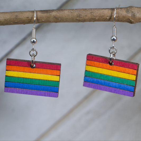 Hand-painted wooden LGBTQ pride flag dangle earrings with vibrant rainbow design and hypoallergenic sterling silver hooks, lightweight equality statement jewelry for pride events and everyday expression