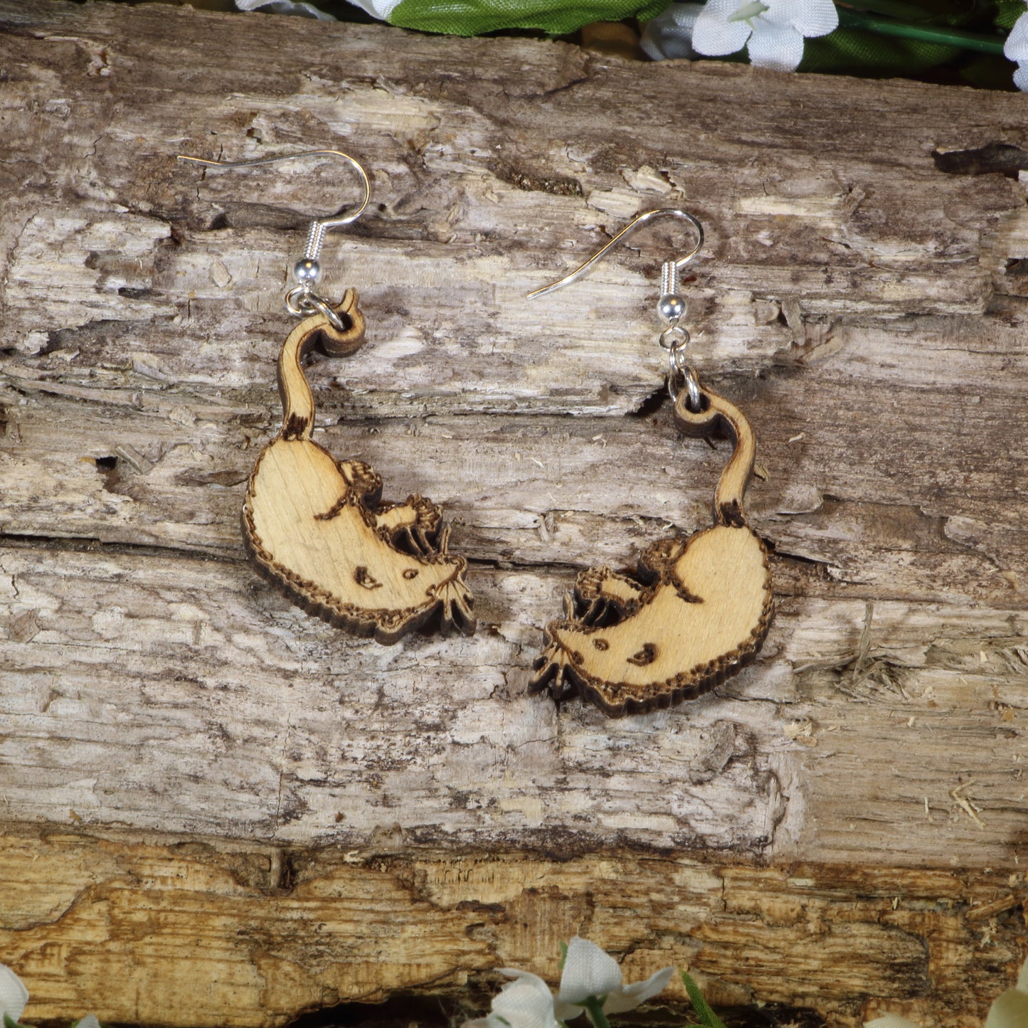 Hand-painted wooden opossum dangle earrings featuring adorable curled-tail opossum designs, hypoallergenic sterling silver hooks, and lightweight woodland animal jewelry for wildlife lovers, nature enthusiasts, and marsupial fans by Cate's Concepts.