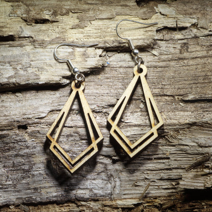 Pair of natural wood Art Deco geometric dangle earrings with elongated diamond-shaped Gatsby design displayed on rustic weathered wood