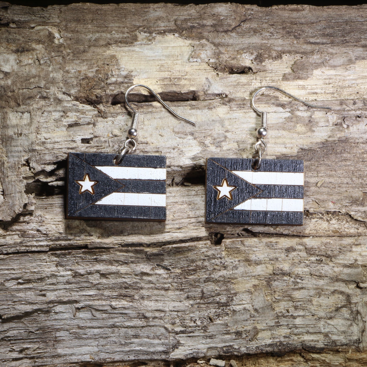 Handcrafted Puerto Rican Black Flag wooden dangle earrings featuring the iconic black-and-white Puerto Rico flag design. Lightweight laser-cut wooden earrings with hypoallergenic .925 sterling silver hooks, perfect for Puerto Rican pride, Boricua heritage, cultural celebrations, patriotic accessories, and everyday wear.