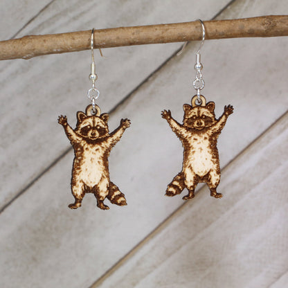 Hand-painted raccoon wooden dangle earrings with playful wildlife design, lightweight hypoallergenic animal jewelry for nature lovers, quirky fashion fans, and raccoon enthusiasts