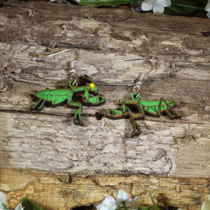 Hand-painted wooden praying mantis dangle earrings featuring realistic green mantis artwork, hypoallergenic sterling silver hooks, and lightweight insect jewelry for bug lovers, entomologists, and nature enthusiasts by Cate's Concepts.