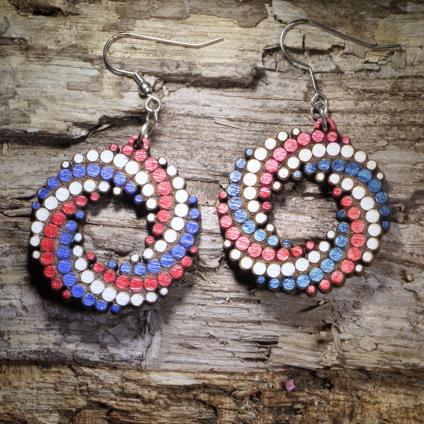 Red, White and Blue Hand-painted colorful dot spiral wooden dangle earrings featuring a bold swirling pattern of colorful dots. Lightweight geometric statement earrings available in multiple color combinations, perfect for art lovers, colorful style, and playful modern outfits.