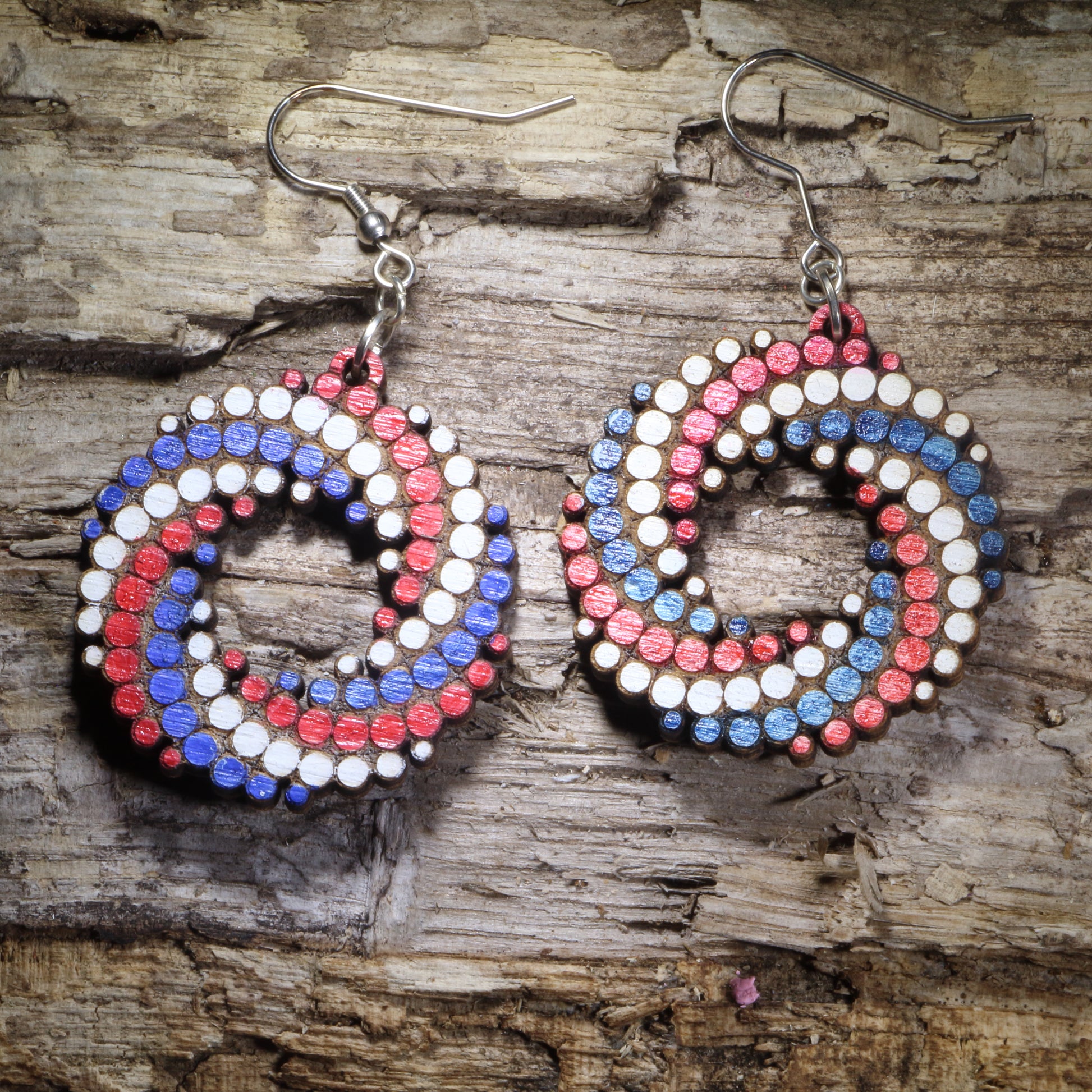 Red, White and Blue Hand-painted colorful dot spiral wooden dangle earrings featuring a bold swirling pattern of colorful dots. Lightweight geometric statement earrings available in multiple color combinations, perfect for art lovers, colorful style, and playful modern outfits.