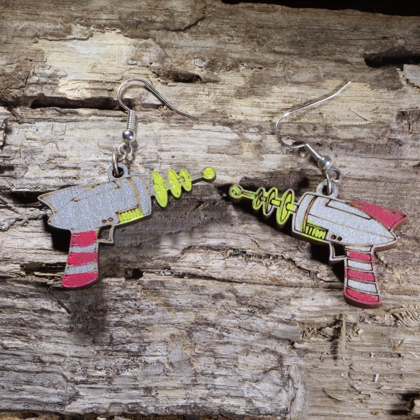 Handcrafted Retro Ray Gun wooden dangle earrings featuring a vintage science fiction blaster inspired by classic space-age adventures. Lightweight laser-cut wooden earrings with hypoallergenic .925 sterling silver hooks, perfect for sci-fi fans, retro futurism lovers, comic convention cosplay, space enthusiasts, and geek culture accessories.