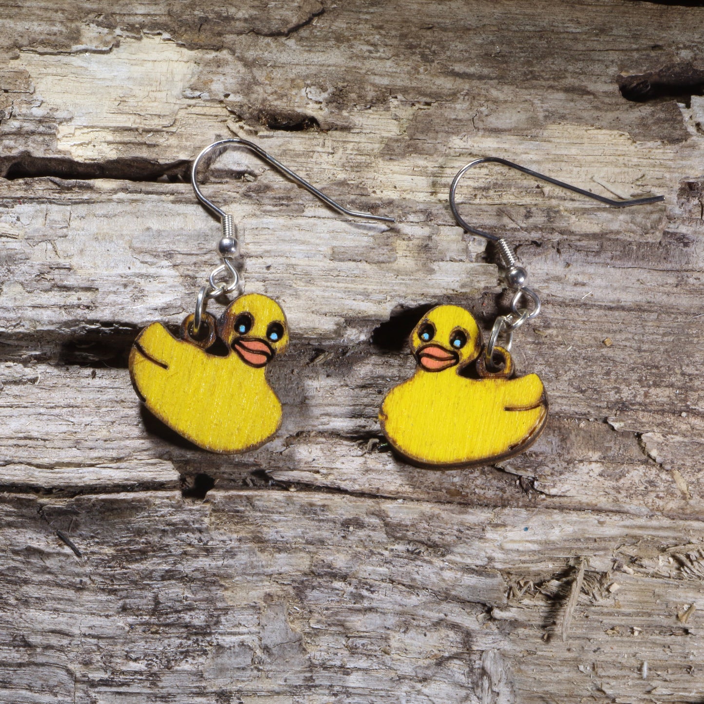 Handcrafted Rubber Duck wooden dangle earrings featuring adorable yellow rubber duck designs. Lightweight laser-cut wooden earrings with hypoallergenic .925 sterling silver hooks, perfect for duck lovers, bath toy fans, animal jewelry collectors, whimsical fashion, and anyone who loves cute novelty accessories.