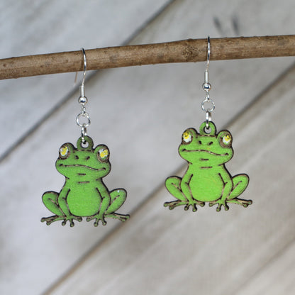 Hand-painted wooden sitting frog dangle earrings with cute amphibian design and hypoallergenic sterling silver hooks, lightweight frog jewelry for nature lovers and playful style by Cate’s Concepts