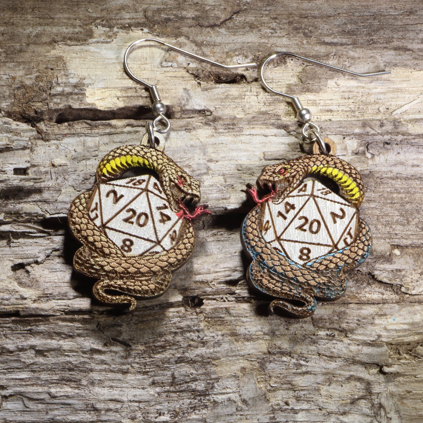 Handcrafted snake and D20 wooden dangle earrings featuring a coiled serpent wrapped around a twenty-sided die. Lightweight laser-cut wooden earrings with hypoallergenic .925 sterling silver hooks, perfect for tabletop RPG players, fantasy gamers, dungeon masters, dice collectors, and role-playing game enthusiasts.