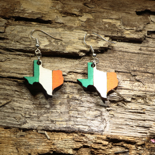 Hand-painted wooden Texas state dangle earrings featuring the outline of Texas painted in the green, white, and orange colors of the Irish flag. Crafted from lightweight wood with hypoallergenic .925 sterling silver hooks, these unique earrings are perfect for Irish Texans, St. Patrick's Day celebrations, Texas pride, Irish heritage, cultural festivals, travel souvenirs, and anyone who loves combining their Irish and Lone Star roots in one bold accessory.