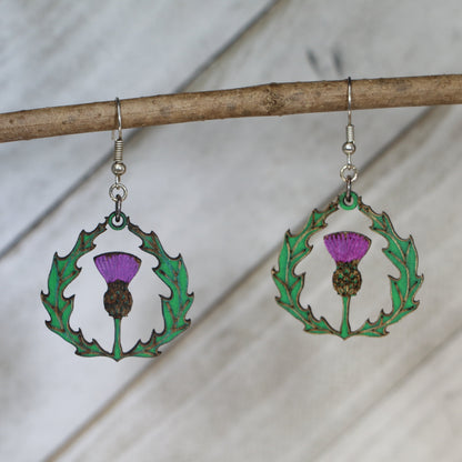 Hand-painted wooden thistle dangle earrings with Celtic Scottish flower design and hypoallergenic sterling silver hooks, lightweight botanical jewelry for heritage lovers and nature-inspired style by Cate’s Concepts

