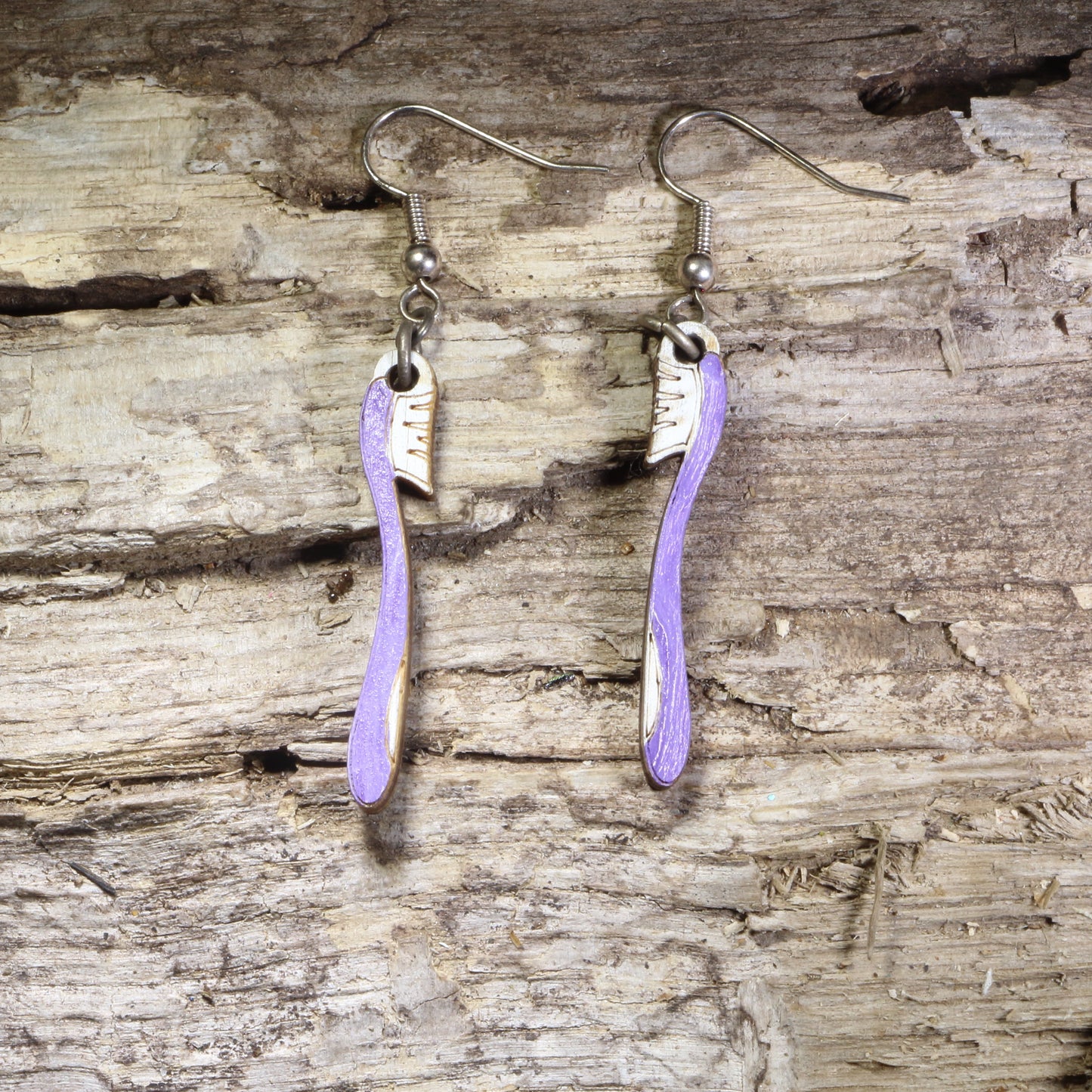Handcrafted toothbrush wooden dangle earrings featuring colorful hand-painted toothbrushes with detailed bristles. Lightweight laser-cut wooden earrings with hypoallergenic .925 sterling silver hooks, perfect for dental hygienists, dentists, dental assistants, dental students, oral health professionals, and fun dental-themed jewelry.