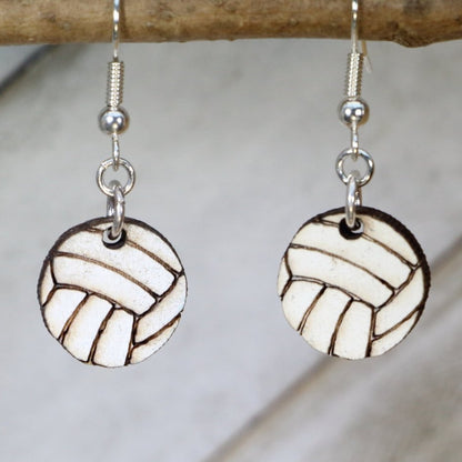 Hand-painted wooden volleyball dangle earrings featuring a detailed ball design with classic panel lines and sporty styling and hypoallergenic sterling silver hooks, lightweight jewelry for volleyball players and sports enthusiasts by Cate’s Concepts