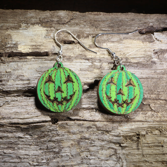Handcrafted Watermelon Jack-o'-Lantern wooden dangle earrings featuring a carved watermelon with a jack-o'-lantern face. Lightweight laser-cut wooden earrings with hypoallergenic .925 sterling silver hooks, perfect for Summerween celebrations, Halloween lovers, watermelon fans, quirky seasonal fashion, and unique novelty jewelry.