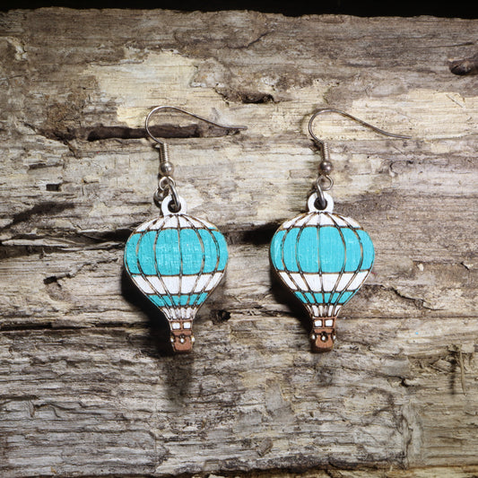 Handcrafted blue hot air balloon wooden dangle earrings featuring colorful hand-painted hot air balloons with engraved details. Lightweight laser-cut wooden earrings with hypoallergenic .925 sterling silver hooks, perfect for travel lovers, adventure seekers, aviation enthusiasts, wanderers, and unique handmade statement jewelry.