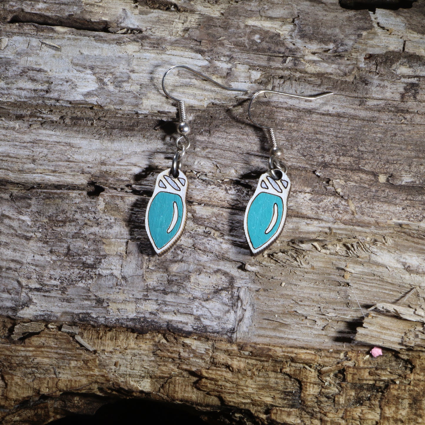 Hand-painted wooden Christmas light bulb dangle earrings featuring classic teal holiday light bulbs with white tops. Crafted from lightweight wood with hypoallergenic .925 sterling silver hooks, these festive Christmas earrings are perfect for holiday parties, Christmas decorating, winter celebrations, stocking stuffers, Christmas light enthusiasts, and anyone who loves cheerful holiday jewelry inspired by classic Christmas lights.