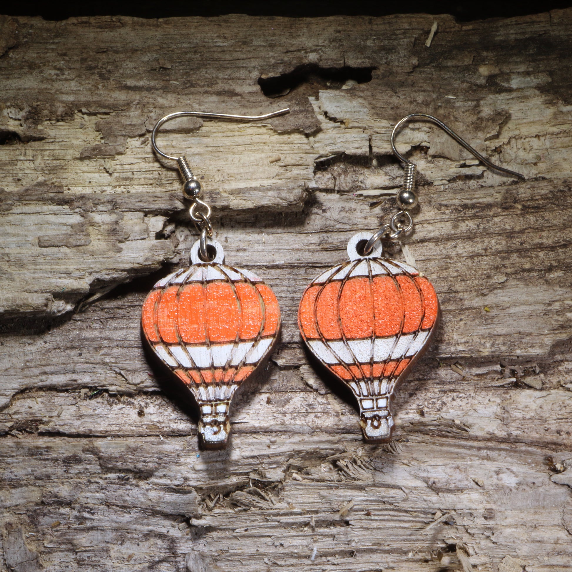 Handcrafted blue hot air balloon wooden dangle earrings featuring colorful hand-painted hot air balloons with engraved details. Lightweight laser-cut wooden earrings with hypoallergenic .925 sterling silver hooks, perfect for travel lovers, adventure seekers, aviation enthusiasts, wanderers, and unique handmade statement jewelry.