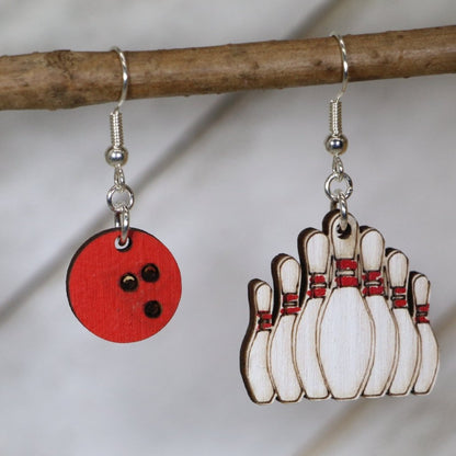 Hand-painted wooden bowling ball and pin dangle earrings featuring a classic black ball with finger holes and standing pin design and hypoallergenic sterling silver hooks, lightweight jewelry for bowlers and league night enthusiasts by Cate’s Concepts

