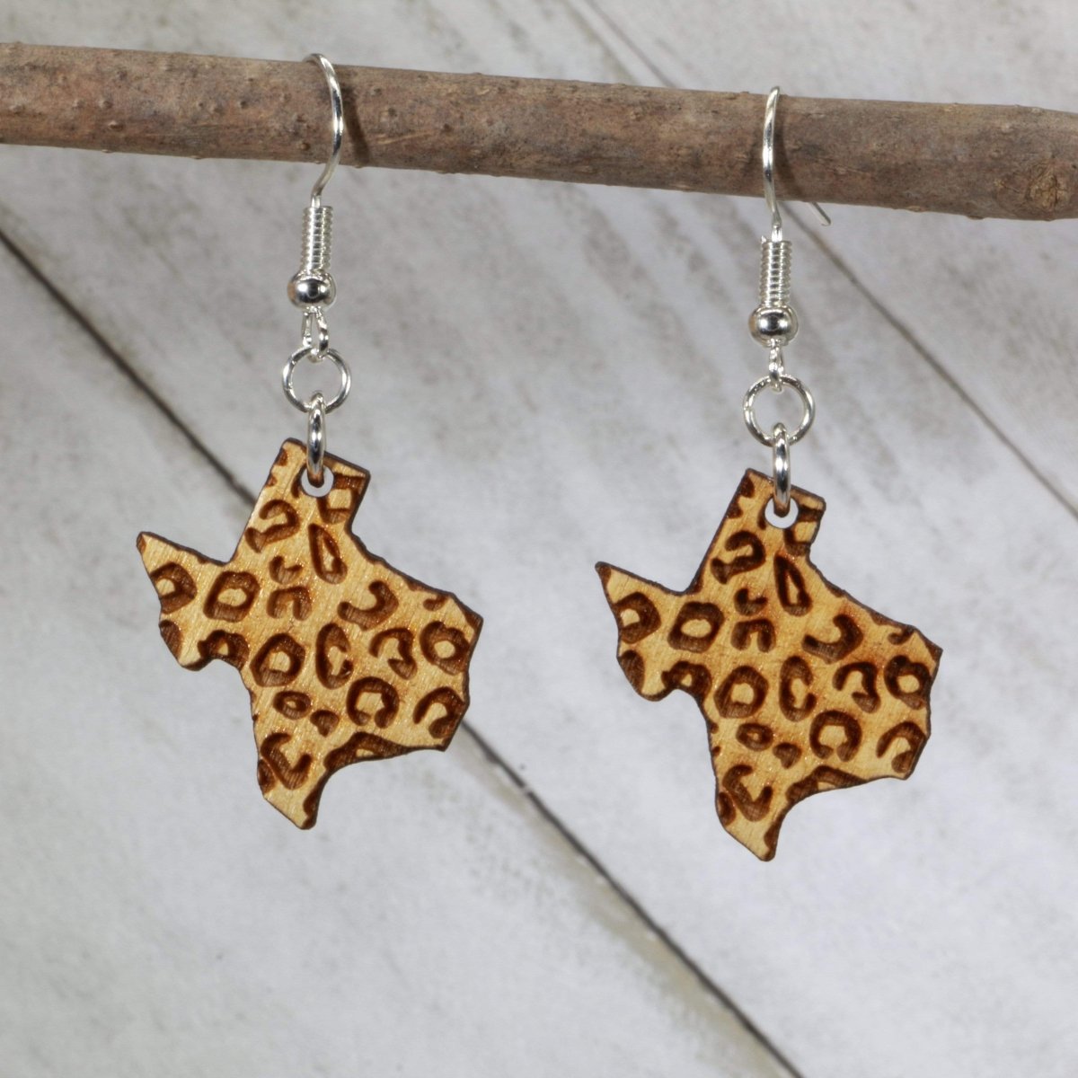 Hand-painted wooden Texas cheetah print dangle earrings with bold state outline design and hypoallergenic sterling silver hooks, lightweight Texas animal print statement jewelry earrings for southern style